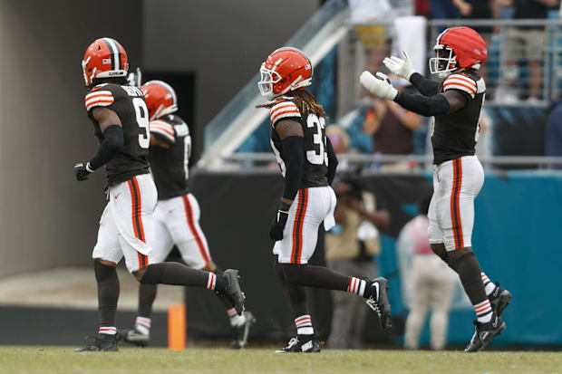 Players run off the field celebrating big play.