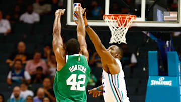 Oct 11, 2017; Charlotte, NC, USA; Boston Celtics center Al Horford (42) shoots the ball over Charlotte Hornets center Dwight Howard (12) in the first half at Spectrum Center. Mandatory Credit: Jeremy Brevard-Imagn Images