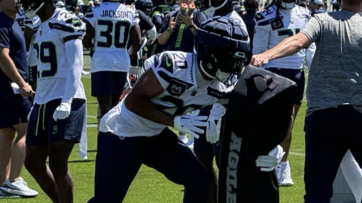 Seattle Seahawks safety Julian Love wraps up for a tackle on a dummy during training camp.