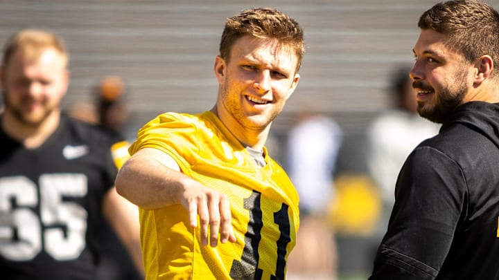 Apr 26, 2025; Iowa City, IA, USA; Iowa quarterback Mark Gronowski (11) talks with defensive lineman Ethan Hurkett (49) during a spring NCAA football open practice at Kinnick Stadium. Mandatory Credit: Joseph Cress/For the Register
