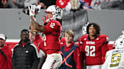 Nov 1, 2025; Raleigh, North Carolina, USA;  North Carolina State Wolfpack wide receiver Teddy Hoffmann (12) catches a pass against Georgia Tech Yellow Jackets defensive back Omar Daniels (9) during the first quarter at Carter-Finley Stadium. Mandatory Credit: Zachary Taft-Imagn Images