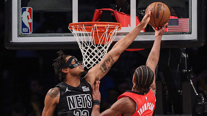 Feb 4, 2025; Brooklyn, New York, USA; Brooklyn Nets center Nic Claxton (33) blocks a shot by Houston Rockets forward Amen Thompson (1) during the second half at Barclays Center. Mandatory Credit: Vincent Carchietta-Imagn Images