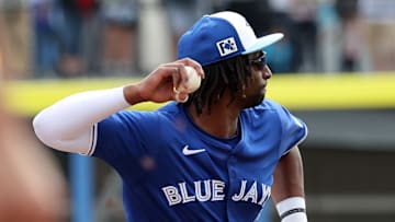 Feb 22, 2025; Dunedin, Florida, USA;  Toronto Blue Jays infielder Charles McAdoo (84) throws the ball to first base for an out during the fifth inning against the New York Yankees at TD Ballpark. Mandatory Credit: Kim Klement Neitzel-Imagn Images