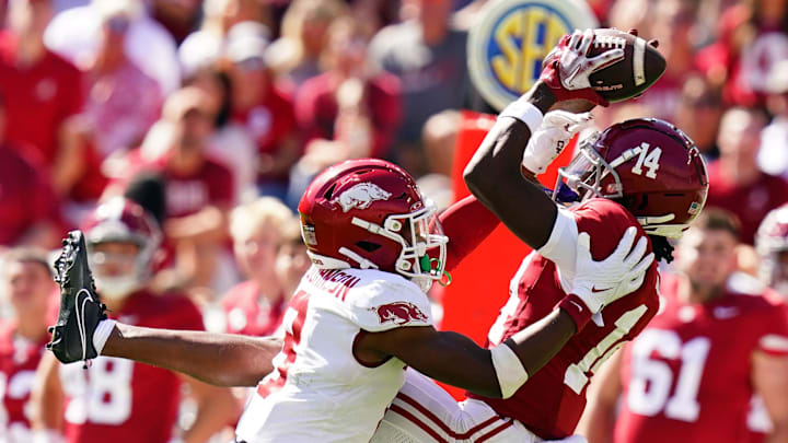 Oct 14, 2023; Tuscaloosa, Alabama, USA; Alabama Crimson Tide wide receiver Jalen Hale (14) tries to hang onto the ball against Arkansas Razorbacks defensive back Jayden Johnson (8) during the second half at Bryant-Denny Stadium. 