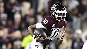 Nov 30, 2024; College Station, Texas, USA; Texas A&M Aggies quarterback Marcel Reed (10) runs the ball during the first quarter against the Texas Longhorns.The Longhorns defeated the Aggies 17-7 at Kyle Field. Mandatory Credit: Maria Lysaker-Imagn Images  