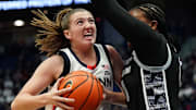 Dec 15, 2024; Storrs, Connecticut, USA; UConn Huskies guard Allie Ziebell (11) drives the ball against Georgetown Hoyas guard Jaeda Wilson (0) in the first half at XL Center. Mandatory Credit: David Butler II-Imagn Images