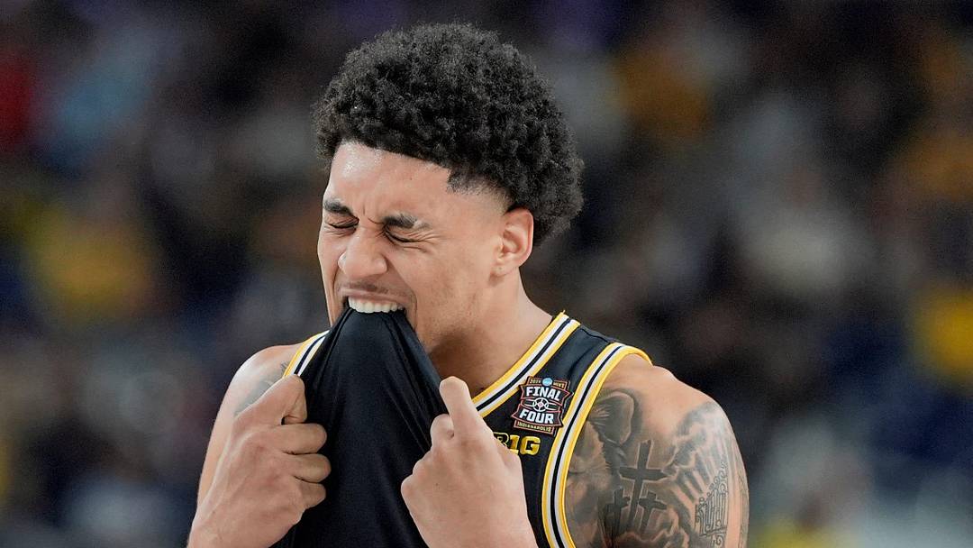 Michigan forward Yaxel Lendeborg (23) bites his jersey following a play in the first half of their Final Four game against Arizona at Lucas Oil Stadium in Indianapolis on Saturday, April 4, 2026.