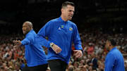 Florida coach Todd Golden (center)