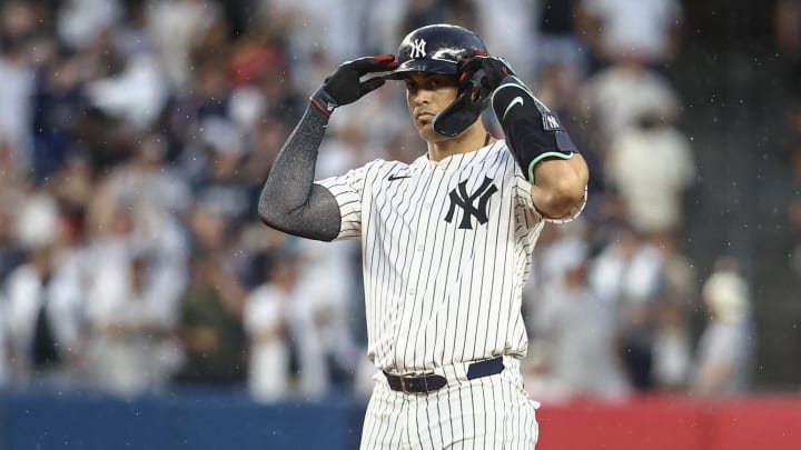 Jun 22, 2024; Bronx, New York, USA;  New York Yankees designated hitter Giancarlo Stanton (27) gestures after hitting a double against the Atlanta Braves in the fourth inning at Yankee Stadium. Mandatory Credit: Wendell Cruz-USA TODAY Sports