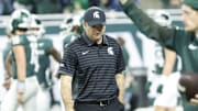 Michigan State Spartans head coach Jonathan Smith walks around during pregame warmups ahead of a game against the Maryland Terrapins at Ford Field in Detroit on Saturday, Nov. 29, 2025.