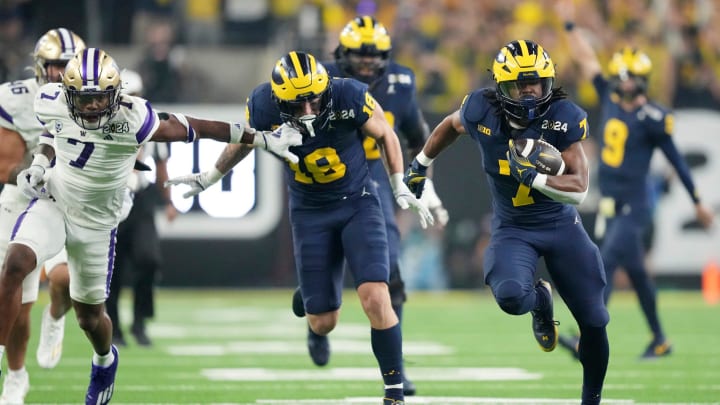 Michigan running back Donovan Edwards (7) runs the ball in for a touchdown in the second quarter during the College Football Playoff national championship game against Washington at NRG Stadium in Houston, Texas on Monday, January 8, 2024.