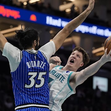 Oct 30, 2025; Charlotte, North Carolina, USA; Charlotte Hornets guard Kon Knueppel (7) drives to the basket against Orlando Magic center Goga Bitadze (35) during the second half at Spectrum Center. Mandatory Credit: Jim Dedmon-Imagn Images