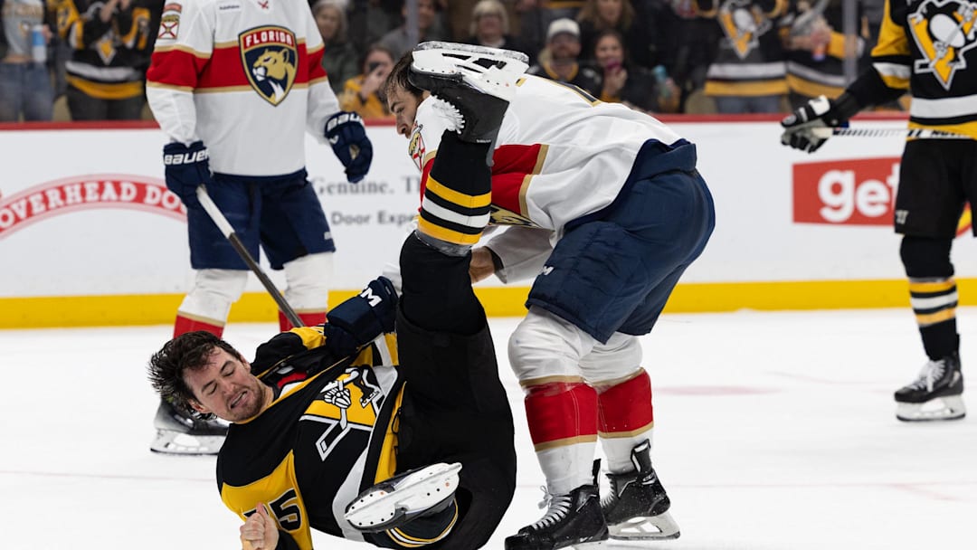 Apr 4, 2026; Pittsburgh, Pennsylvania, USA; Pittsburgh Penguins defenseman Connor Clifton (75) goes to the ground while fighting Florida Panthers center Luke Kunin (71) during the second period at PPG Paints Arena. Mandatory Credit: Mark Alberti-Imagn Images