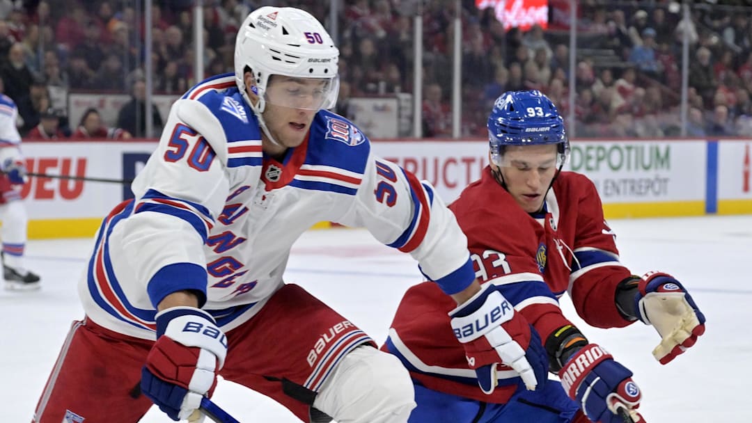 Oct 18, 2025; Montreal, Quebec, CAN; New York Rangers forward Will Cuylle (50) and Montreal Canadiens forward Ivan Demidov (93) battle for the puck during the first period at the Bell Centre.