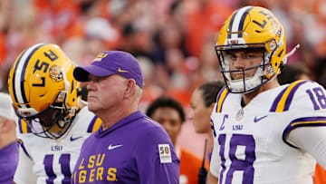 Aug 30, 2025; Clemson, South Carolina, USA; LSU Tigers head coach Brian Kelly and quarterback Garrett Nussmeier (18) look on during warmups before the game against the Clemson Tigers at Memorial Stadium. Mandatory Credit: Ken Ruinard-USA TODAY Network via Imagn Images