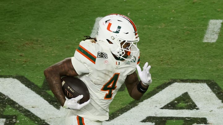 Jan 19, 2026; Miami Gardens, FL, USA; Miami Hurricanes running back Mark Fletcher Jr. (4) carries the ball against the Indiana Hoosiers in the third quarter during the College Football Playoff National Championship game at Hard Rock Stadium. Mandatory Credit: Kim Klement Neitzel-Imagn Images
