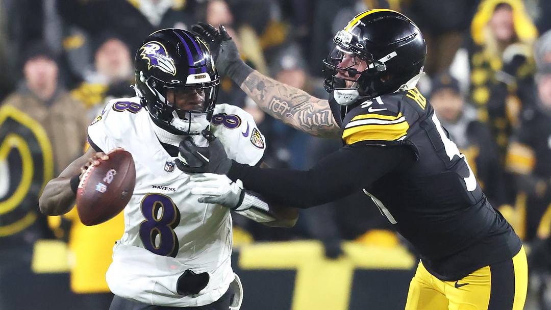 Jan 4, 2026; Pittsburgh, Pennsylvania, USA;  Baltimore Ravens quarterback Lamar Jackson (8) scrambles with the ball as Pittsburgh Steelers linebacker Nick Herbig (51) cases during the fourth quarter at Acrisure Stadium. Mandatory Credit: Charles LeClaire-Imagn Images