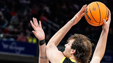 Nate Bittle works for a shot over Michigan State's Carson Cooper. Bittle riddled the Spartans for 22 points and 11 rebounds, but the rest of Oregon's offense struggled against the pressure defense at the Gainbridge Fieldhouse.
