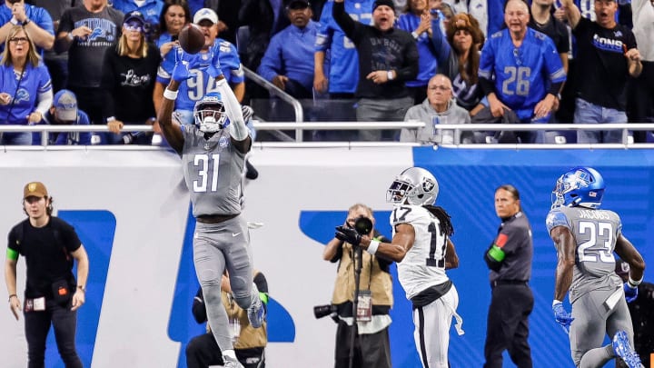 Lions safety Kerby Joseph intercepts a pass intended for Raiders wide receiver Davante Adams during the first half at Ford Field on Monday, Oct. 30, 2023.