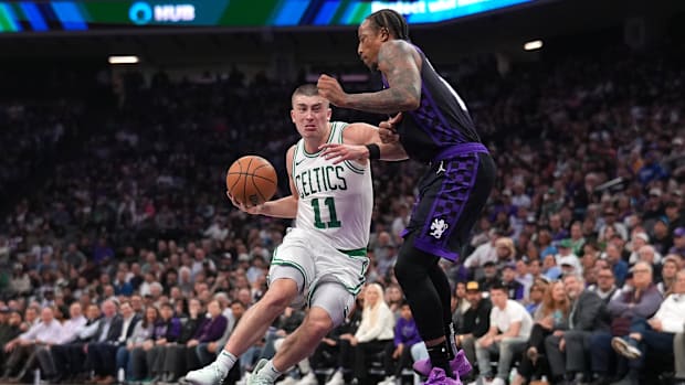 Mar 24, 2025; Sacramento, California, USA; Boston Celtics guard Payton Pritchard (11) drives to the hoop next to Sacramento K