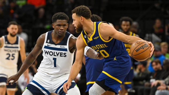 Nov 27, 2022; Minneapolis, Minnesota, USA; Golden State Warriors guard Stephen Curry (30) protects the ball from Minnesota Timberwolves guard Anthony Edwards (1) during the second half at Target Center.