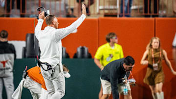 Texas Longhorns head coach Steve Sarkisian walks over the student section to encourage them to stop throwing items on the field after a controversial call by the referees.
