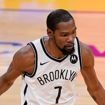 Feb 13, 2021; San Francisco, California, USA; Brooklyn Nets forward Kevin Durant (7) dribbles the ball against Golden State Warriors guard Stephen Curry (30) in the second quarter at the Chase Center. Mandatory Credit: Cary Edmondson-Imagn Images