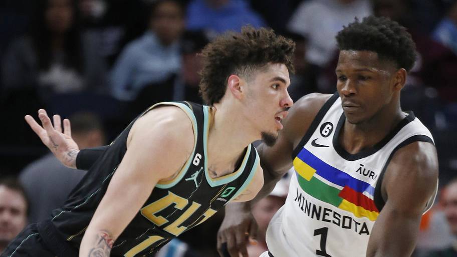 Charlotte Hornets guard LaMelo Ball works past Minnesota Timberwolves forward Anthony Edwards.