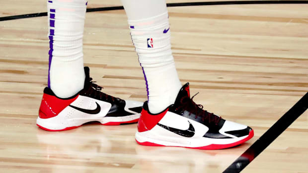 Anthony Davis's white, red, and black Nike sneakers.