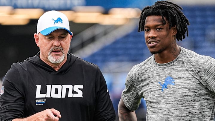 Detroit Lions offensive coordinator John Morton, left, talks to wide receiver Jameson Williams (1) 