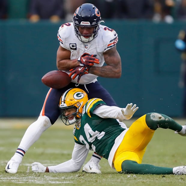 Green Bay Packers cornerback Carrington Valentine (24) forces a fumble by Chicago Bears wide receiver DJ Moore (2) on Sunday.