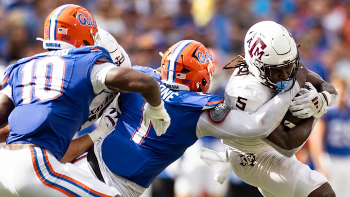 Sep 14, 2024; Gainesville, Florida, USA; Florida Gators defensive end Justus Boone (1) tackles Texas A&M Aggies running back Amari Daniels (5) during the first half at Ben Hill Griffin Stadium. Mandatory Credit: Matt Pendleton-Imagn Images