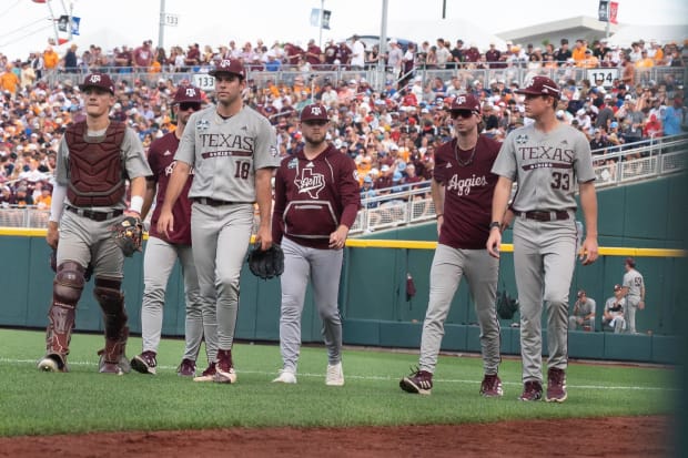 Texas A&M Aggies starting pitcher Ryan Prager (18) and catcher Jackson Appel (20) walk to the dugout before a game.