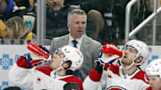Feb 22, 2024; Pittsburgh, Pennsylvania, USA; Montreal Canadiens head coach Martin St. Louis (top) looks on from the bench against the Pittsburgh Penguins during the second period at PPG Paints Arena. The Penguins won 4-1. Mandatory Credit: Charles LeClaire-Imagn Images