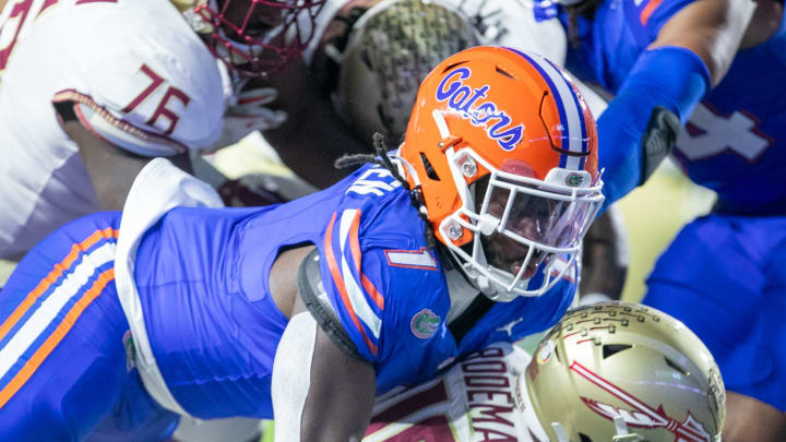 Florida Gators defensive end Princely Umanmielen (1) sacks Florida State Seminoles quarterback Tate Rodemaker (18) during first half action as Florida takes on Florida State at Steve Spurrier Field at Ben Hill Griffin Stadium in Gainesville, FL on Saturday, November 25, 2023. [Alan Youngblood/Gainesville Sun]