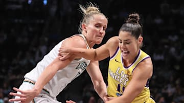 Jul 3, 2025; Brooklyn, New York, USA;  Los Angeles Sparks guard Kelsey Plum (10) and New York Liberty forward Leonie Fiebich (13) fight for a loose ball in the first quarter at Barclays Center. Mandatory Credit: Wendell Cruz-Imagn Images
