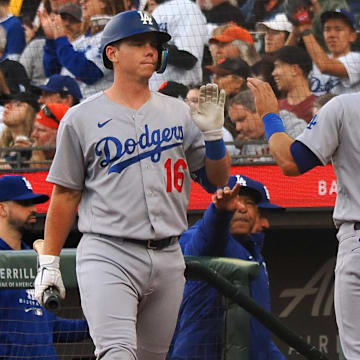 Aug 2, 2022; San Francisco, California, USA;  Los Angeles Dodgers catcher Austin Barnes (15) high fives designated hitter Will Smith (16) after scoring a run against the San Francisco Giants during the second inning at Oracle Park. 