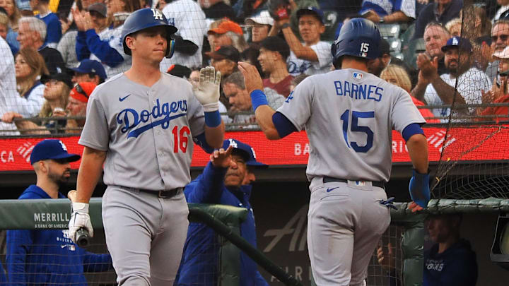 Aug 2, 2022; San Francisco, California, USA;  Los Angeles Dodgers catcher Austin Barnes (15) high fives designated hitter Will Smith (16) after scoring a run against the San Francisco Giants during the second inning at Oracle Park. 