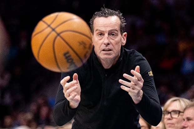 Kenny Atkinson toss the ball to an official