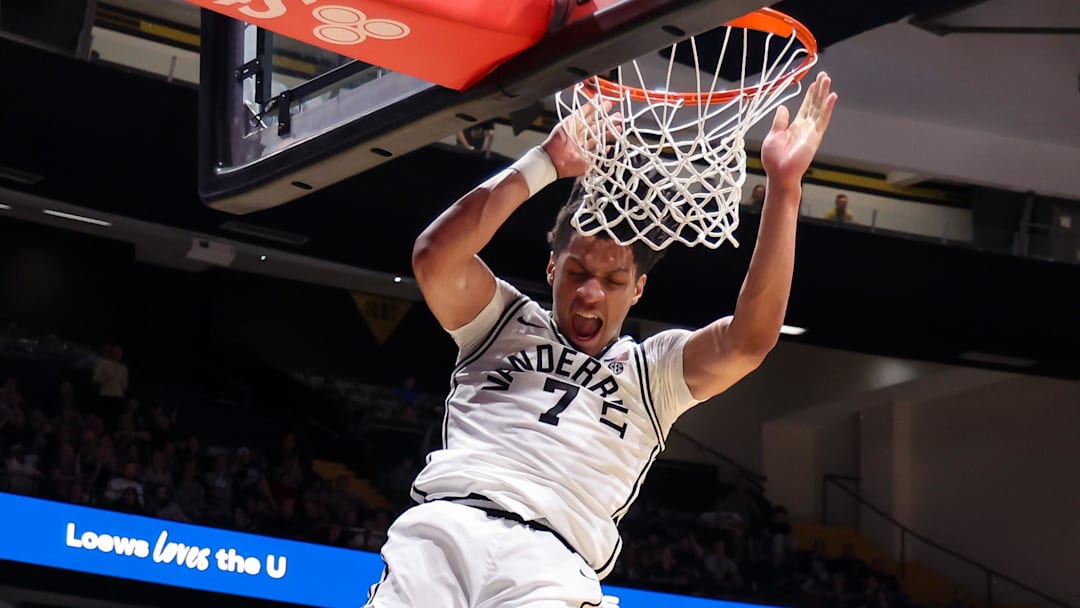 Feb 14, 2026; Nashville, Tennessee, USA;  Vanderbilt Commodores guard Chandler Bing (7) dunks the ball over Texas A&M Aggies guard Jacari Lane (5) during the second half at Memorial Gymnasium. Mandatory Credit: Steve Roberts-Imagn Images