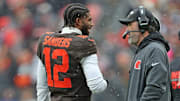 Cleveland Browns quarterback Shedeur Sanders (12) talks with coach Kevin Stefanski during a game against the Tennessee Titans on Dec. 7, 2025, in Cleveland.