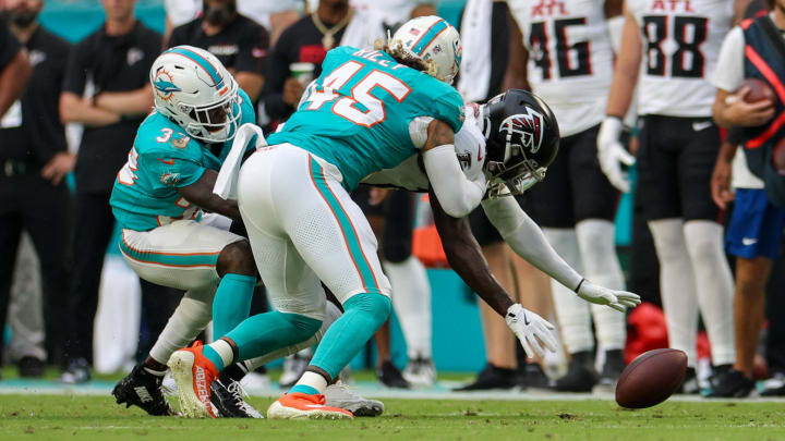 Atlanta Falcons wide receiver Chris Blair (19) fumbles the ball while pressured by Miami Dolphins linebacker Duke Riley (45) and cornerback Siran Neal in the first quarter during preseason at Hard Rock Stadium.