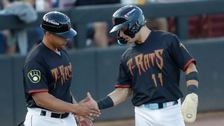 Wisconsin Timber Rattlers' manager Victor Estevez (7) congratulates Andrew Fischer (11) getting to third base during their baseball game against the Quad Cities River Bandits Wednesday, August 27, 2025, at Neuroscience Group Field at Fox Cities Stadium in Grand Chute, Wisconsin. Quad City won 9-5.