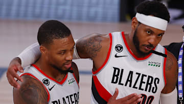 Aug 9, 2020; Lake Buena Vista, Florida, USA;  Carmelo Anthony #00 of the Portland Trail Blazers and Damian Lillard celebrate a win against the Philadelphia 76ers following a game at Visa Athletic Center at ESPN Wide World Of Sports Complex on August 09, 2020 in Lake Buena Vista, Florida.  Mandatory Credit: Kevin C. Cox/Pool Photo-Imagn Images