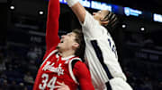 Feb 19, 2025; University Park, Pennsylvania, USA; Penn State Nittany Lions forward Yanic Konan Niederhauser (14) attempts to tip the ball into the basket during the first half against the Nebraska Cornhuskers at Bryce Jordan Center.