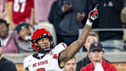Sep 11, 2025; Winston-Salem, North Carolina, North Carolina State Wolfpack wide receiver Keenan Jackson (8) celebrates a first down against the Wake Forest Demon Deacons defensive back Karon Prunty (3) in the second half at Allegacy Federal Credit Union Stadium. Mandatory Credit: Luke Jamroz-Imagn Images 