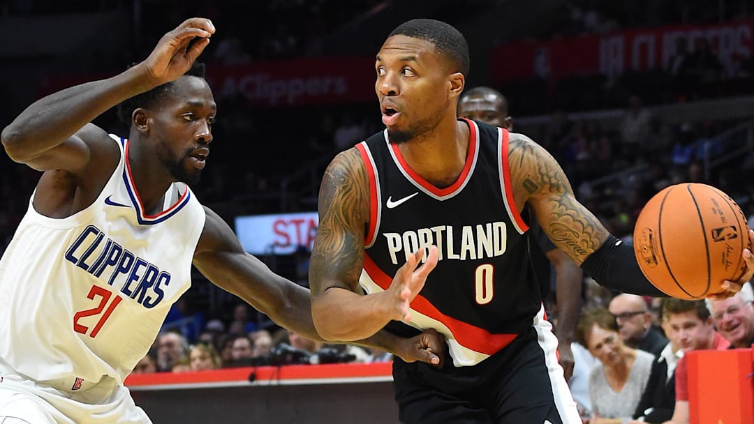 Oct 8, 2017; Los Angeles, CA, USA; Los Angeles Clippers guard Patrick Beverley (21) defends Portland Trail Blazers guard Damian Lillard (0) in the first half of the game at Staples Center. Mandatory Credit: Jayne Kamin-Oncea-Imagn Images