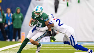 Dec 2, 2023; New Orleans, LA, USA; Tulane Green Wave tight end Alex Bauman (87) runs with the ball against Southern Methodist Mustangs safety Isaiah Nwokobia (23) during the first half at Yulman Stadium. Mandatory Credit: Stephen Lew-Imagn Images