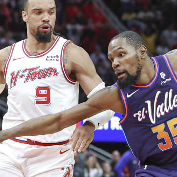 Feb 23, 2024; Houston, Texas, USA; Phoenix Suns forward Kevin Durant (35) controls the ball as Houston Rockets forward Dillon Brooks (9) defends during the fourth quarter at Toyota Center. Mandatory Credit: Troy Taormina-USA TODAY Sports