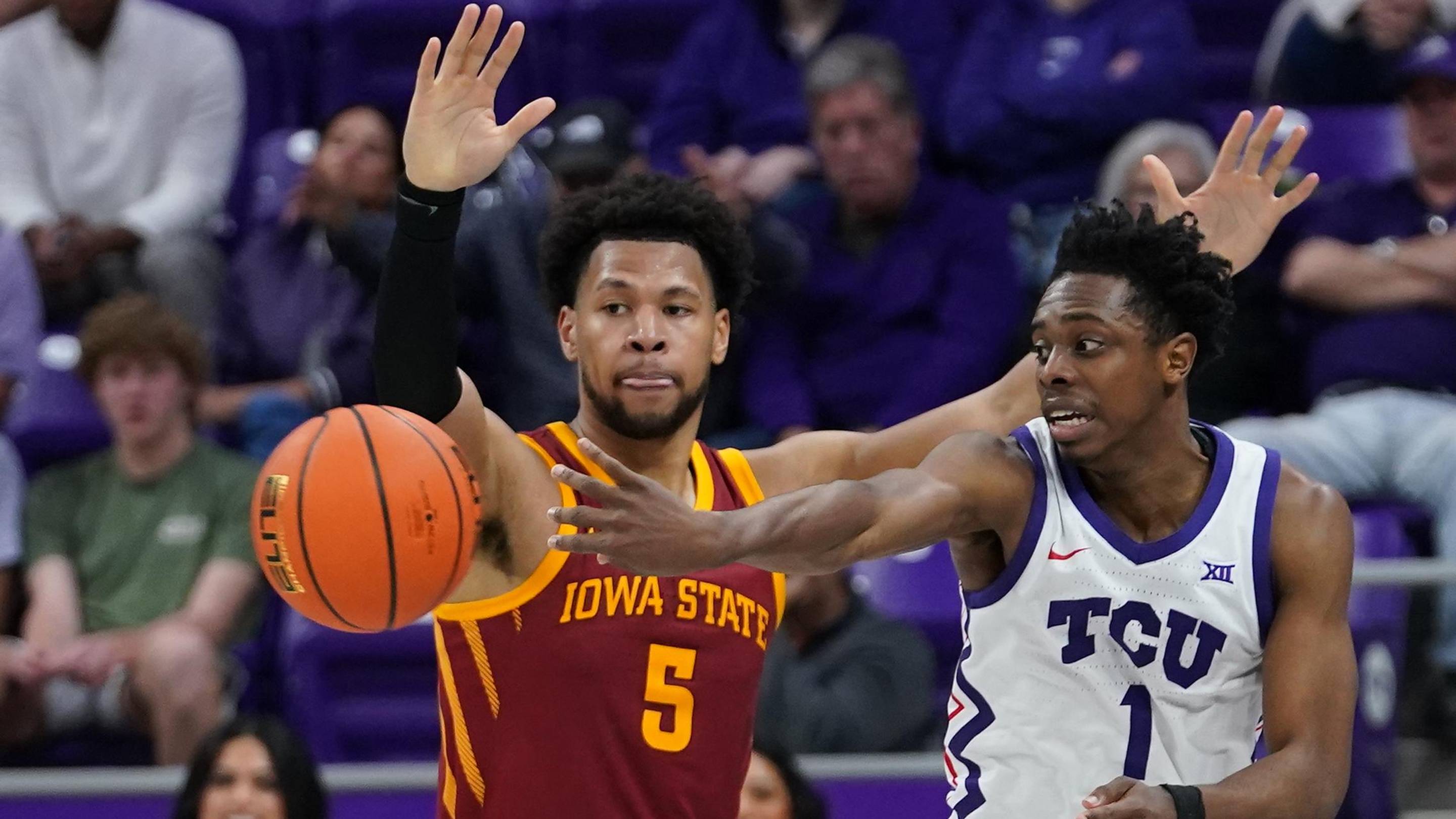 Feb 10, 2026; Fort Worth, Texas, USA; TCU Horned Frogs guard Jayden Pierre (1) passes the ball as Iowa State Cyclones forward Joshua Jefferson (5) defends during the second half at Ed and Rae Schollmaier Arena.